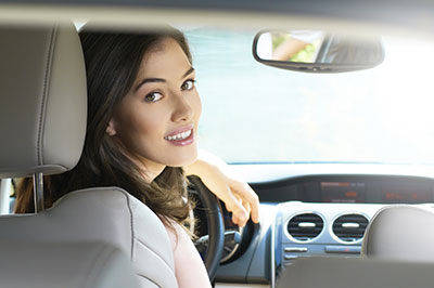 woman sitting inside her car