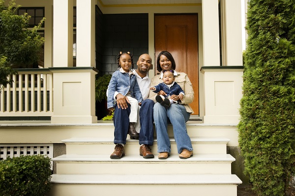 A family sitting on their front porch