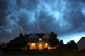 image of house with storm clouds